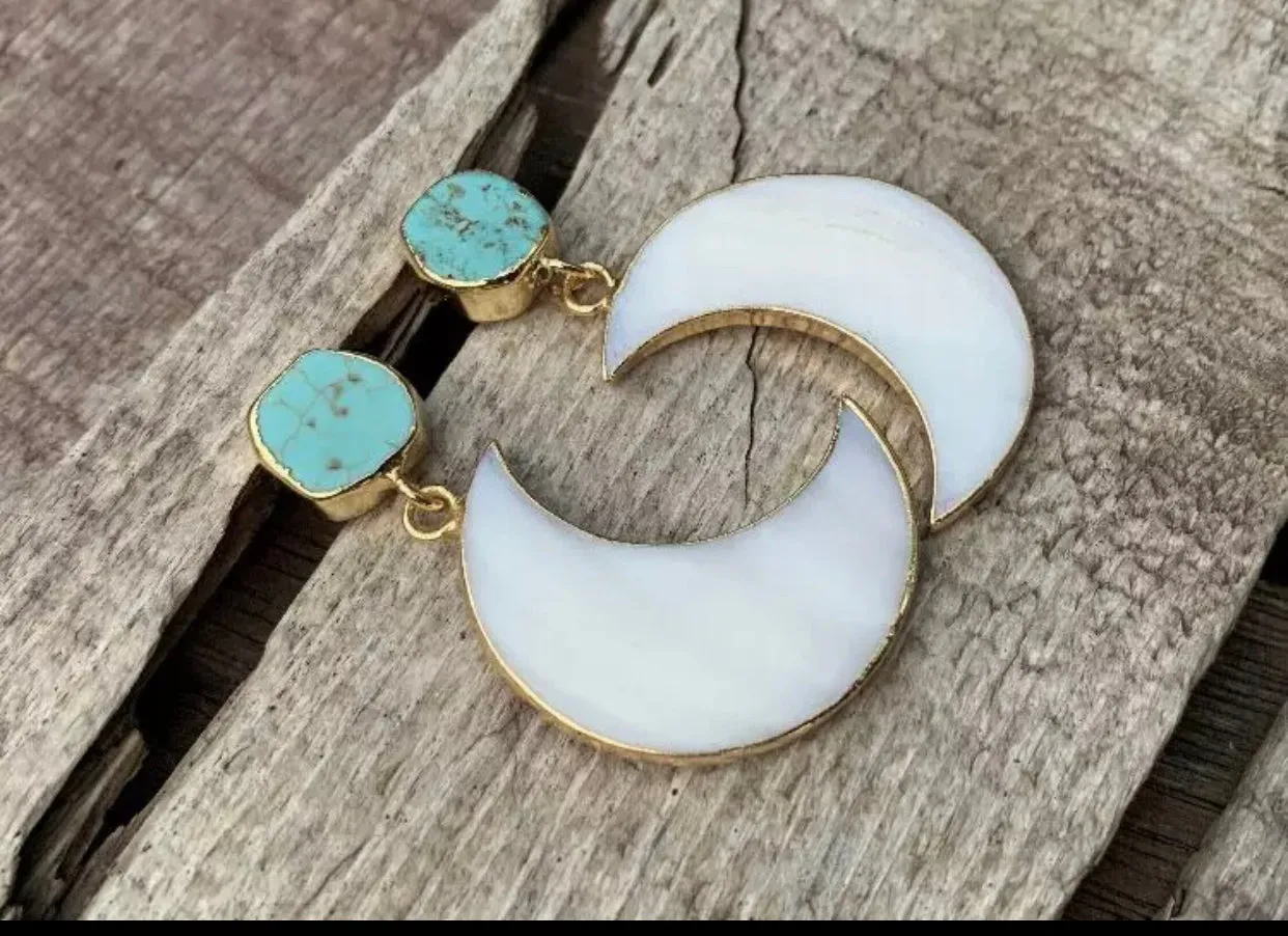 Gorgeous mother of Pearl crescent moon earrings dipped in gold, with raw turquoise.